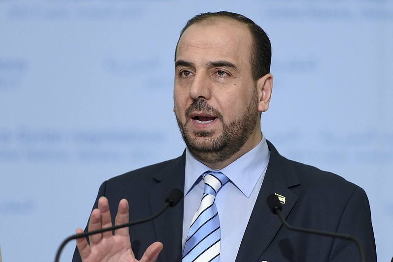 
              Syria's main opposition High Negotiations Committee (HNC) leader Nasr al-Hariri, informs the media after the round of negotiation  with  the UN Special Envoy of the Secretary-General for Syria Staffan de Mistura  at the European headquarters of the United Nations in Geneva, Switzerland, Wednesday, March 1, 2017. (Martial Trezzini/Keystone via AP)
            