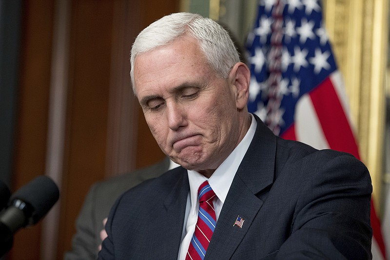 
              Vice President Mike Pence pauses while speaking before administering the oath of office to Energy Secretary Rick Perry, left, Thursday, March 2, 2017, in the Eisenhower Executive Office Building on the White House complex in Washington. (AP Photo/Andrew Harnik)
            