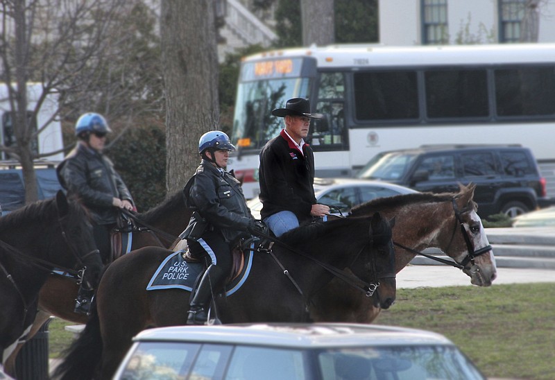 
              In this photo provided by the Interior Department shows Interior Secretary Ryan Zinke arriving for his first day of work at the Interior Department in Washington, Thursday, March 2, 2017, aboard Tonto, an 17-year-old Irish sport horse.  (Interior Department via AP)
            