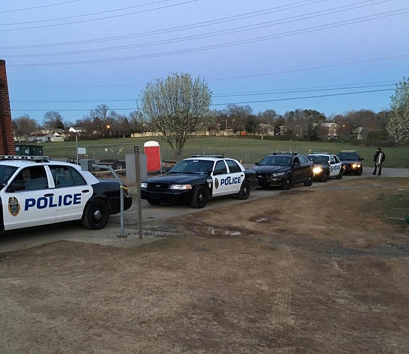 Police cars holding arrestees sit in the driveway leading to the Bradley County Jail on Thursday. Several Cleveland Police Department officers and at least one McMinn County deputy sat for more than two hours awaiting admittance to the booking area.