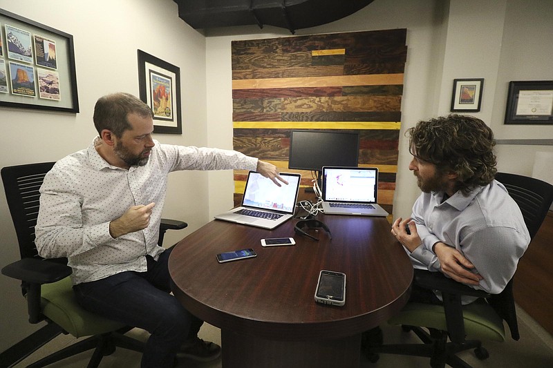 Staff Photo by Dan Henry / The Chattanooga Times Free Press- 2/23/17. Alex Cruikshank, left, and Dr. Andrew Bailey speak about a brain-monitoring program that are using EMOTIV headsets to livestream athletes brainwaves. 