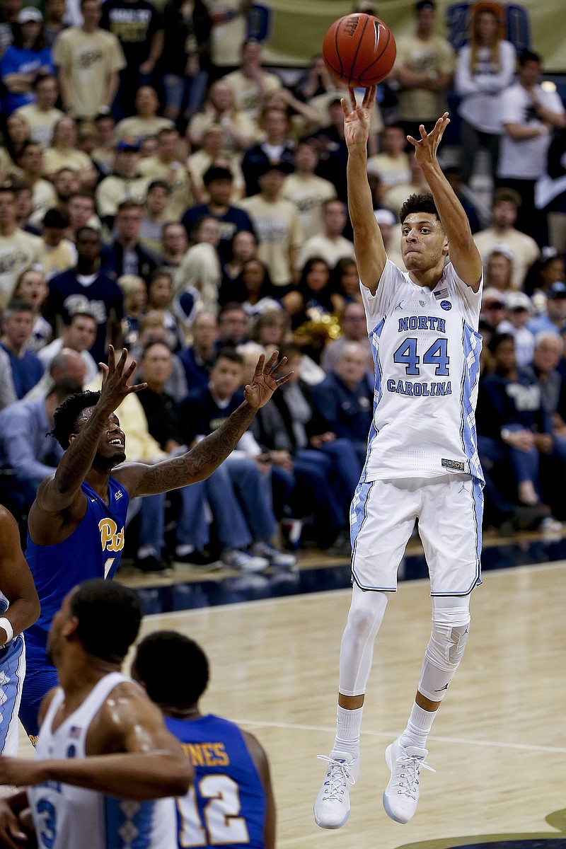 
              FILE - In  this Feb. 25, 2017, file photo, North Carolina's Justin Jackson (44) shoots for three over Pittsburgh's Jamel Artis (1) during the second half of an NCAA college basketball game, in Pittsburgh. Jackson has expanded his 3-point range so well that he's made himself an ACC player of the year candidate for No. 5 North Carolina entering Saturday's rivalry game with No. 17 Duke. (AP Photo/Keith Srakocic, File)
            