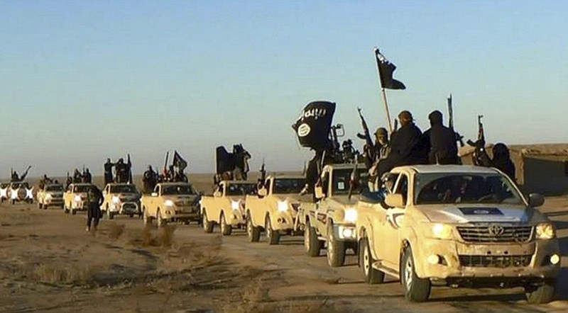 
              FILE - In this undated file photo released by a militant website, which has been verified and is consistent with other AP reporting, militants of the Islamic State group hold up their weapons and wave flags on their vehicles, in a convoy on a road leading to Iraq, from Raqqa, Syria. A major battle to liberate the northern Syrian city of Raqqa from Islamic State militants is looming, with U.S. officials looking to build on momentum from the battlefields in Mosul. Armed with a new Pentagon plan to “rapidly defeat” the militants in both countries, President Donald Trump is now mulling options for upping the fight, which a top U.S. commander says he expects to be concluded within six months. (Militant website via AP, File)
            