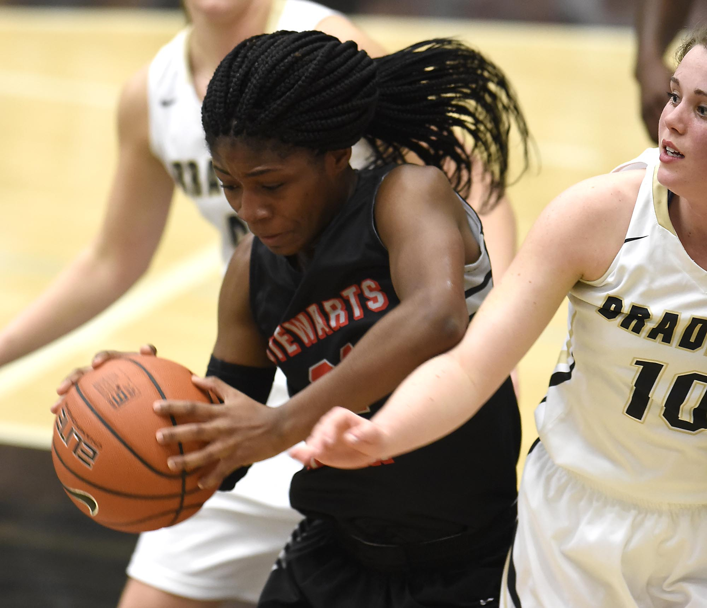 Stewarts Creek's Jamya Rogers (21) pulls a rebound away from Bradley's Emma Kate Brown (10). The Stewarts Creek Red Hawks visited the Bradley Central Bears in TSSAA girls sub state basketball action on March 4, 2017.