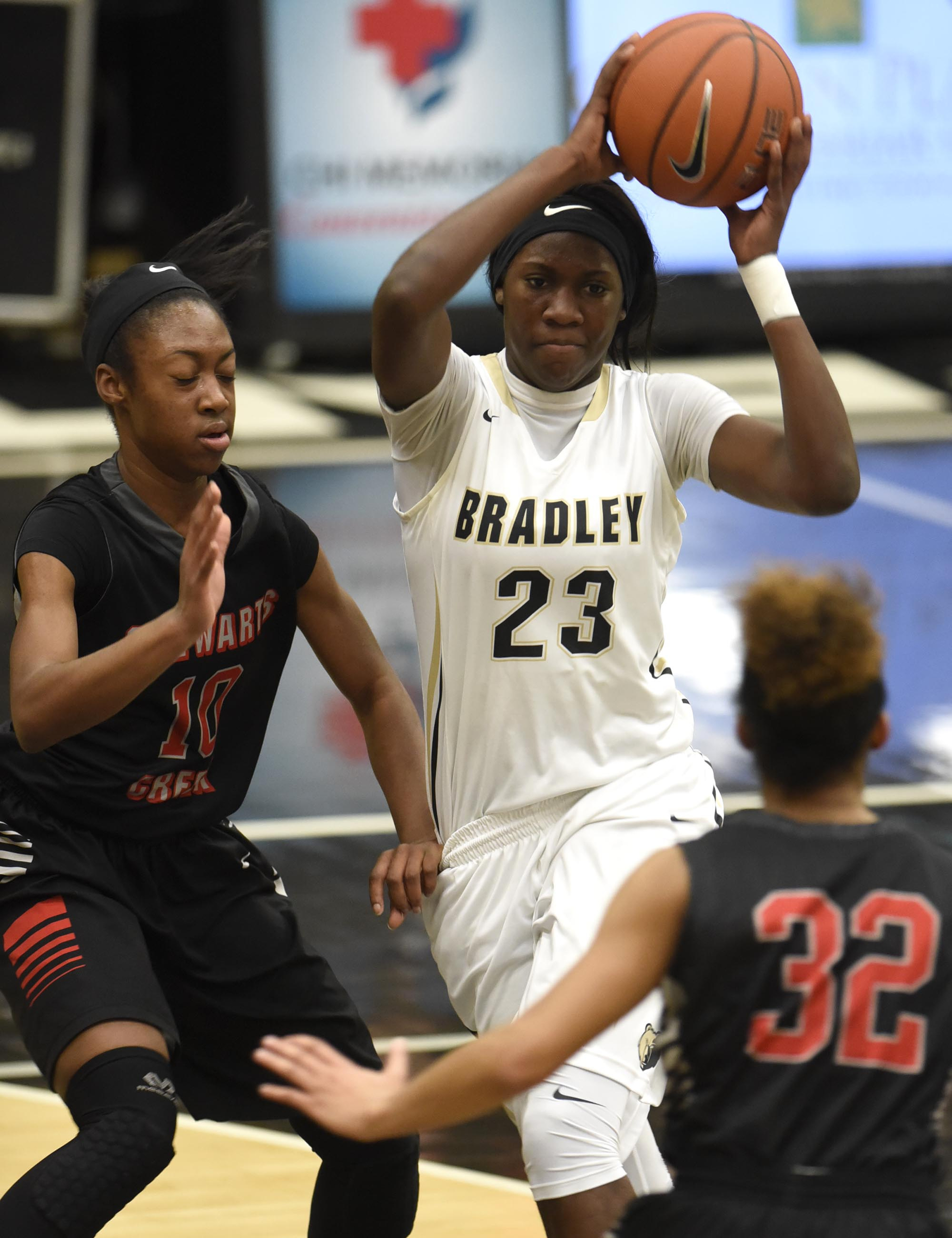 Bradley's Rhyne Howard (23) passes as she drives the lane. The Stewarts Creek Red Hawks visited the Bradley Central Bears in TSSAA girls sub state basketball action on March 4, 2017.