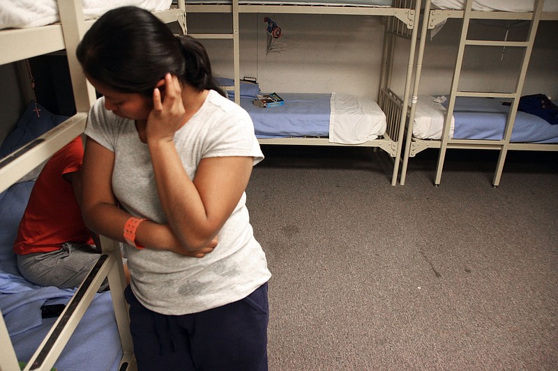 
              FILE - In this Sept. 10, 2014, file photo, an unidentified Guatemalan woman stands inside a dormitory in the Artesia Family Residential Center, a federal detention facility for undocumented immigrant mothers and children in Artesia, N.M. The nation's immigration courts are already overwhelmed, facing a backlog of more than half a million cases. Recent directives from President Donald Trump's administration to step up enforcement of immigration laws and expanding the number of people considered priorities for deportation could funnel even more people into the overloaded immigration court system. (AP Photo/Juan Carlos Llorca, File)
            