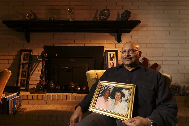 
              This photo taken Feb. 27, 2017, shows East Ridge, Tennessee, resident Andre Boaz posing with a portrait of his great-aunt Mary Jackson, left, and mother Aurellia Mitchell Boaz who were both featured in the recent movie "Hidden Figures".(Dan Henry/Chattanooga Times Free Press via AP)
            