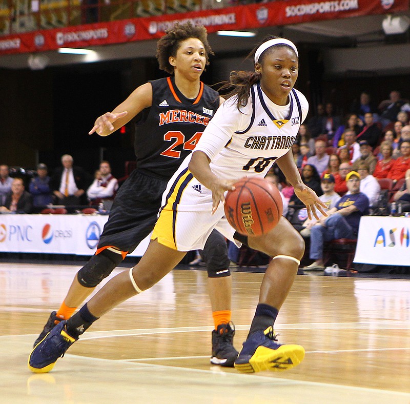 UTC senior Queen Alford dribbles past Mercer's Kahlia Lawrence during the SoCon championship game Sunday in Asheville, N.C. UTC won 61-59.