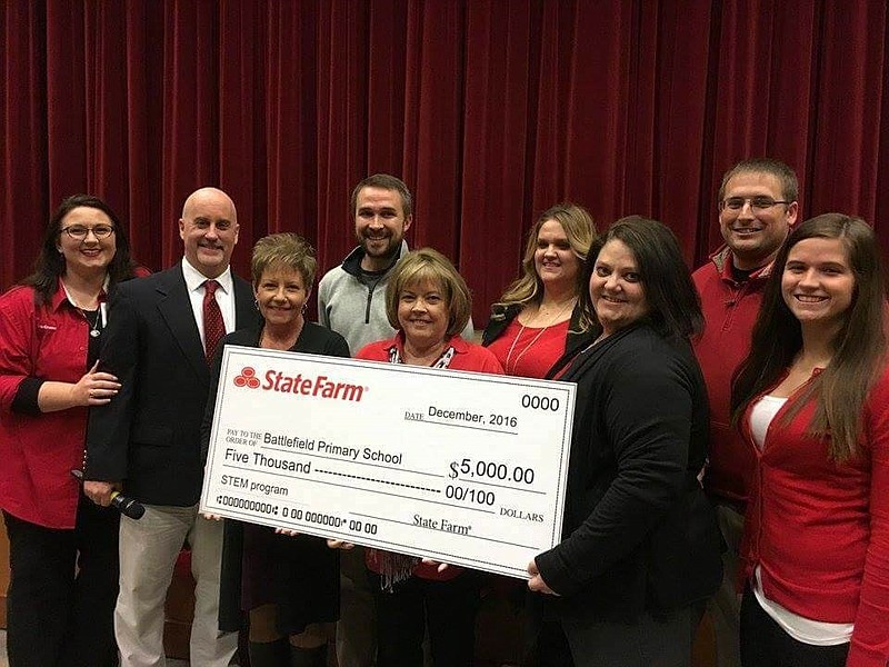 State Farm presents Battlefield Primary Principal Geoff Rhodes with $5,000 after the school won a grant through the national insurance company.