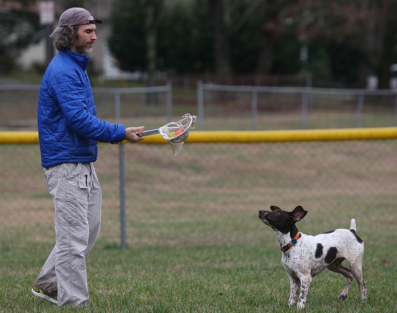In this 2013 file photo, Ben Sedwick plays fetch with his 20-week-old German shorthaired pointer pup, Gus, in the outfield of the small ball field off of Timberlinks Drive. The park is the site of Wagner Field and a recently removed playground.