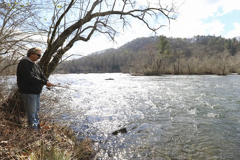 Staff Photo by Dan Henry / The Chattanooga Times Free Press- 2/15/17. Shannon Smith from Georgetown, Tenn, fishes for trout on the Hiwassee River on Wednesday, February 15, 2017. 