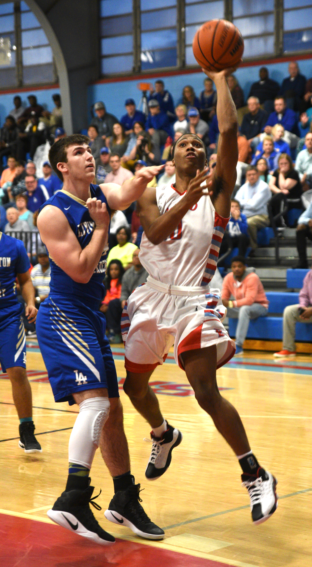 Brainerd's Kentrell Evans is guarded by Livingston's Wade Neely Monday, March 6, 2017 at Brainerd High School.