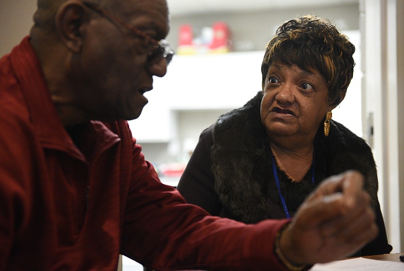 Winifred Henry, right, and Fred Brown talk while dispersing food to public housing residents Thursday, March 2, 2017 at Dogwood Manor on Gateway Avenue.