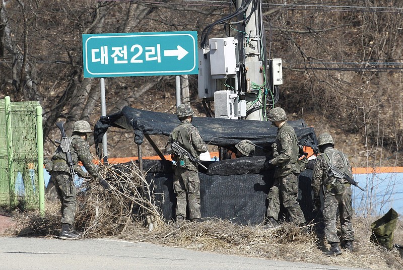 South Korea army soldiers install a tent in Yeoncheon, South Korea, near the border with North Korea, Monday, March 6, 2017. North Korea on Monday fired four banned ballistic missiles that flew about 1,000 kilometers (620 miles), with three of them landing in Japan's exclusive economic zone, South Korean and Japanese officials said, in an apparent reaction to huge military drills by Washington and Seoul that Pyongyang insists are an invasion rehearsal. (AP Photo/Ahn Young-joon)