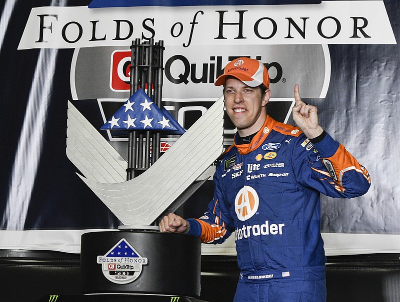 
              Brad Keselowski poses with the trophy in victory lane after winning a NASCAR Monster Cup series auto race at Atlanta Motor Speedway in Hampton, Ga., Sunday, March 5, 2017. (AP Photo/John Amis)
            