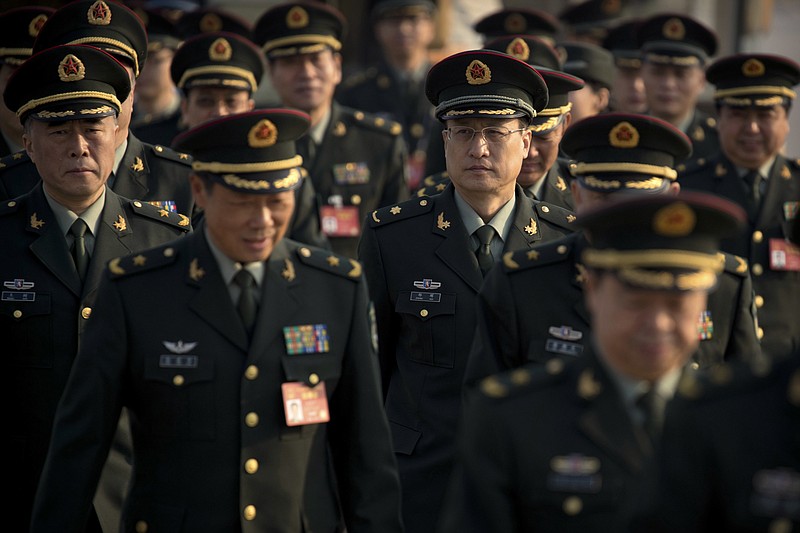 
              FILE - In this Saturday, March 4, 2017 file photo, delegates from China's People's Liberation Army (PLA) arrive at the Great Hall of the People to attend a plenary session of the National People's Congress in Beijing. While the U.S. military remains the dominant force in Asia and the world, China has been moving from quantity to quality and is catching up quickly in equipment, organization and capability, and is increasingly able to project power far from its shores. (AP Photo/Mark Schiefelbein, File)
            
