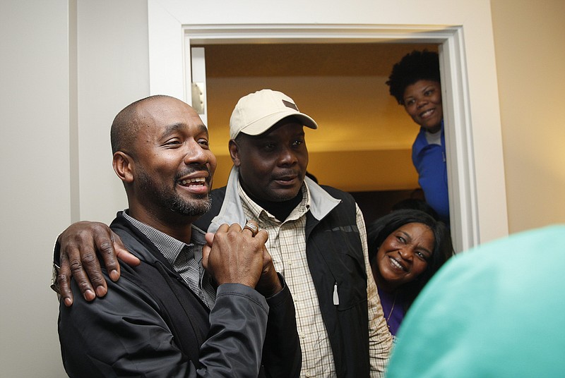 District 8 City Council candidate Anthony Byrd, left, reacts after being told he defeated incumbent Moses Freeman.