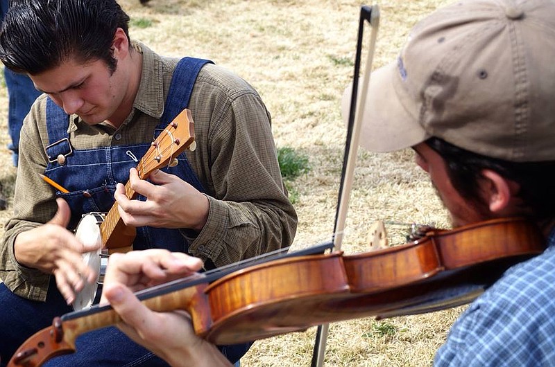 Moses Nelligan and Coleman Akin do a little pickin' on the lawn.