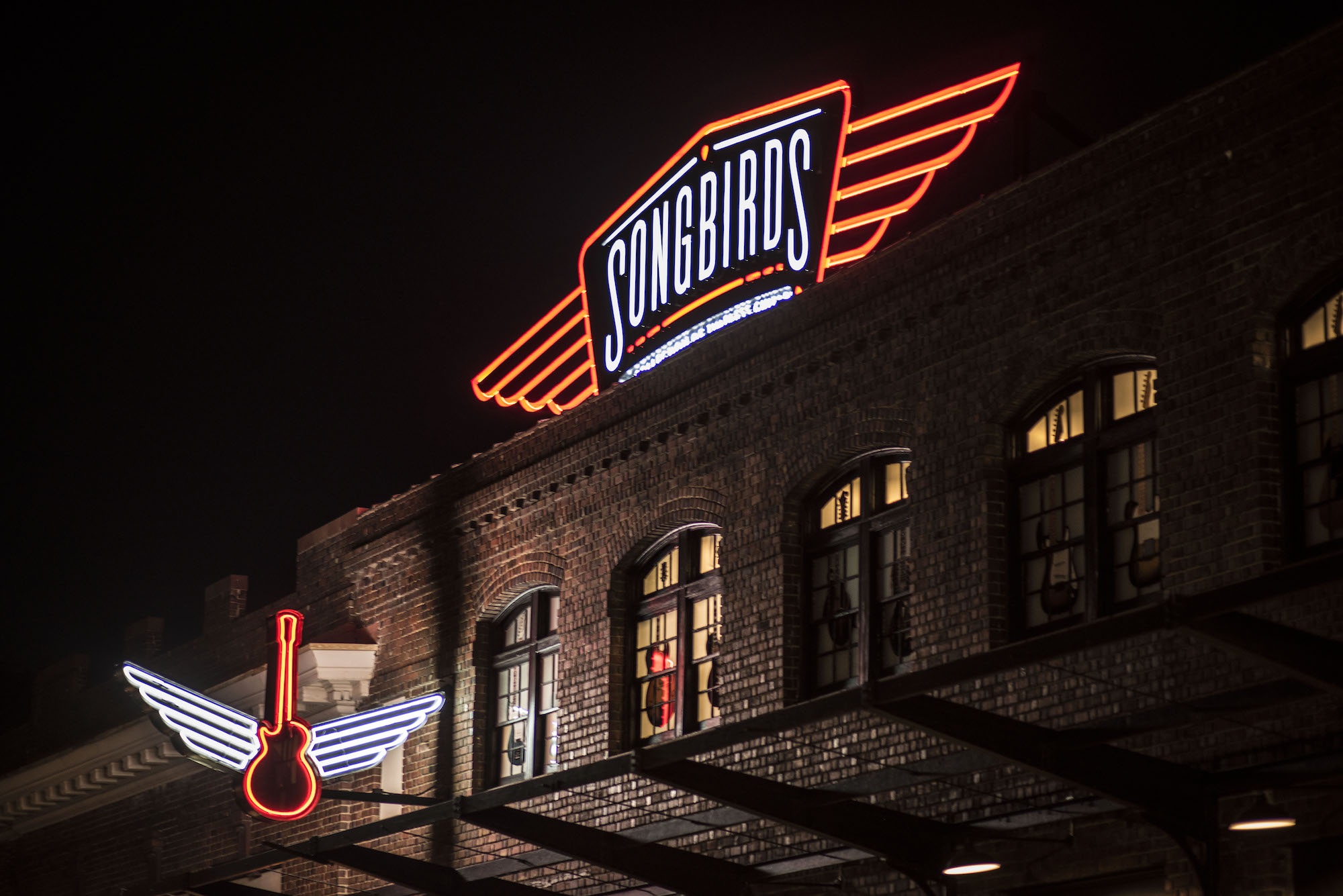 The Songbirds Guitar Museum sign shines over Station Street at the Chattanooga Choo Choo complex.