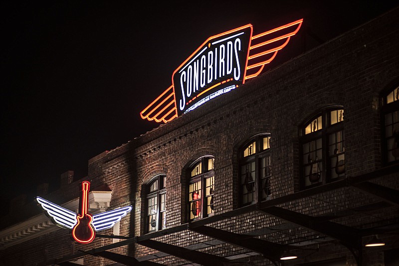 The Songbirds Guitar Museum sign shines over Station Street at the Chattanooga Choo Choo complex.