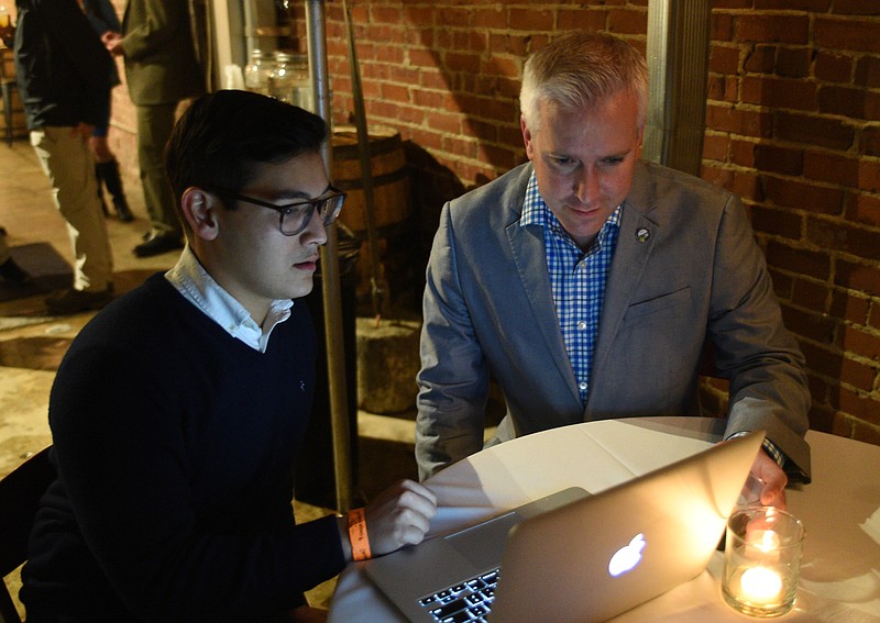 Councilman Chris Anderson, right, looks at election numbers with Joda Thongnopnua Tuesday, March 7, 2017 at the Tennessee Stillhouse. 