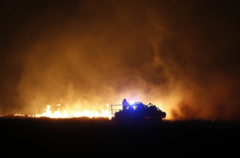 
              Firefighters from across Kansas and Oklahoma battle a wildfire near Protection, Kan., Monday, March 6, 2017. (Bo Rader/The Wichita Eagle via AP)
            