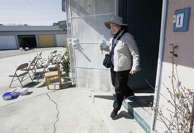 
              In this March 1, 2017 photo, displaced resident Hien Nguyen exits the home of her grandson who has also been displaced for flood damage to his residence while interviewed in San Jose, Calif. When the floodwaters rushed in last month in San Jose, a firefighter hauled Nguyen to safety. She left behind the two-bedroom apartment she shared with a roommate for $1,000 a month, managing only to take her identification and her phone. (AP Photo/Jeff Chiu)
            