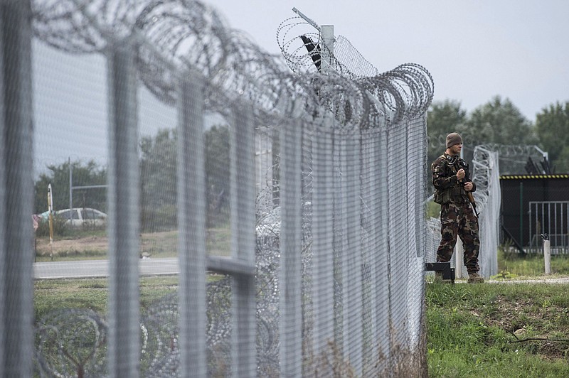 
              FILE - In this Sept. 21, 2016 file photo a Hungarian soldier patrols at the transit zone at Hungary's southern border with Serbia near Tompa, 169 km southeast of Budapest, Hungary. Hungary's Prime Minister Viktor Orban, an early supporter of U.S. President Donald Trump, has ordered the reinforcement of fences on Hungary’s southern borders to keep out migrants, many of whom are Muslims. (Sandor Ujvari/MTI via AP, file)
            