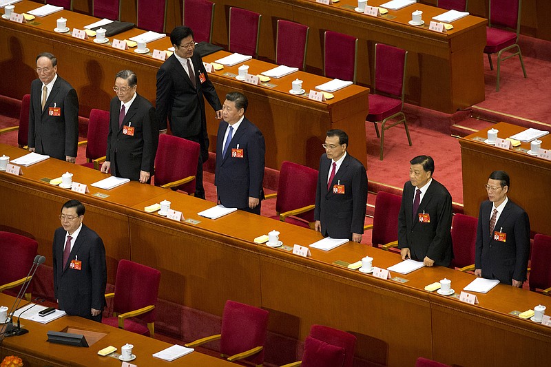 
              FILE - In this Sunday, March 5, 2017 file photo, members of the Politburo Standing Committee, from left, Wang Qishan, Yu Zhengsheng, President Xi Jinping, Premier Li Keqiang, Liu Yunshan, Zhang Gaoli, and Zhang Dejiang, in front row, stand during the start of the opening session of China's annual National People's Congress in the Great Hall of the People in Beijing. The Communist Party's 19th National Congress, anticipated for November, is expected to usher in a second five year term as general secretary for Xi - China's most powerful leader in decades - along with a major infusion of new blood into the party's governing bodies. (AP Photo/Mark Schiefelbein, File)
            