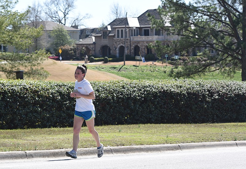 Melissa Hennessy, 33, runs her 4-day-a-week route along Riverview Road in North Chattanooga Wednesday as she trains for the April 2, Cherry Blossom 10-Miler in Washington, D.C. Statistics reveal people in North Chattanooga are the healthiest, percentage wise, in the area.