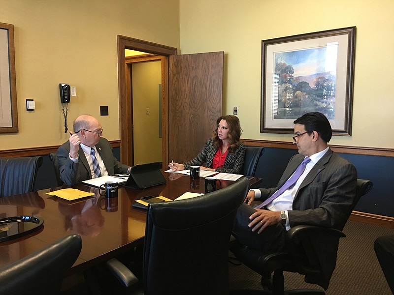 Hamilton County commissioners Randy Fairbanks, left, Sabrena Smedley and Greg Martin, who serve on the commission's education committee, discuss topics for an upcoming meeting with the county school board. Smedley, who chairs the committee, called for county commissioners and school board members to work together "and not against each other."