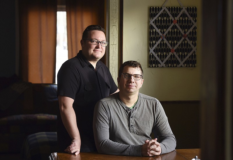 
              In this Feb. 10, 2017 photo, Billy Mawhiney, left, and his husband, Kyle Margheim pose for a portrait in their home in Sioux Falls, S.D. The pair spent more than two years going through criminal background checks, submitting financial disclosure statements and attending parenting classes before they could become foster parents.  A bill that would give new legal protections to adoption agencies and foster groups that cite religious reasons for denying services is one step away from becoming law in South Dakota. Critics say it would allow state-funded child-placement agencies to discriminate against children or prospective parents. (Jay Pickthorn/The Argus Leader via AP)
            