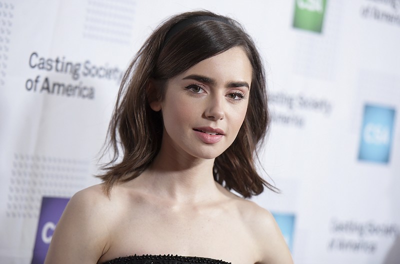 
              FILE - In this Jan. 19, 2017, file photo, Lily Collins arrives at the 32nd annual Artios Awards at the Beverly Hilton Hotel in Beverly Hills, Calif. Collins has forgiven her father, Phil Collins, in a new book of essays released on March 7, 2017. (Photo by Richard Shotwell/Invision/AP, File)
            