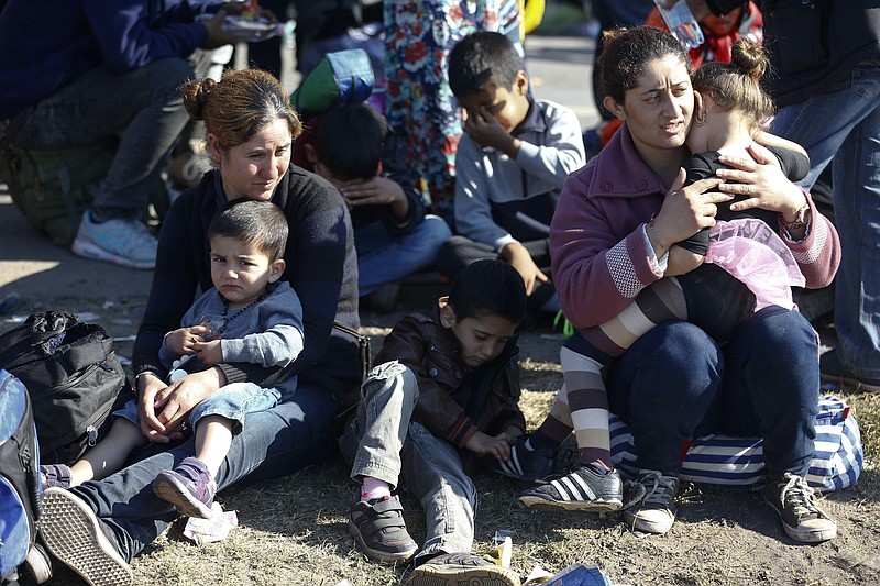 
              FILE - In this Sept. 9. 2015 file photo a group of migrants rest near the Hungarian border with Serbia, in Roszke, southern Hungary. A spokesman for Hungary's governing Fidesz party says Wednesday March 8, 2017 its lawmakers will likely submit a new law regulating nongovernmental organizations within two weeks. Fidesz spokesman Janos Halasz says the law is aimed at revealing the foreign funding received by "agent organizations" seeking to influence Hungarian politics.   (AP Photo/Matthias Schrader, file)
            