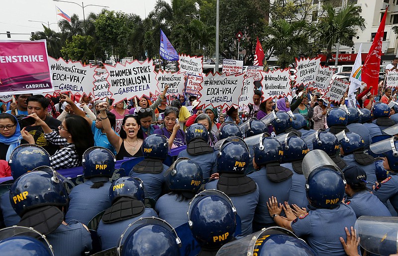 
              Police block women during a rally at the U.S. Embassy to mark International Women's Day Wednesday, March 8, 2017 in Manila, Philippines. Women all over the world mark the women's day with rallies and protests to highlight the role of women in society. (AP Photo/Bullit Marquez)
            