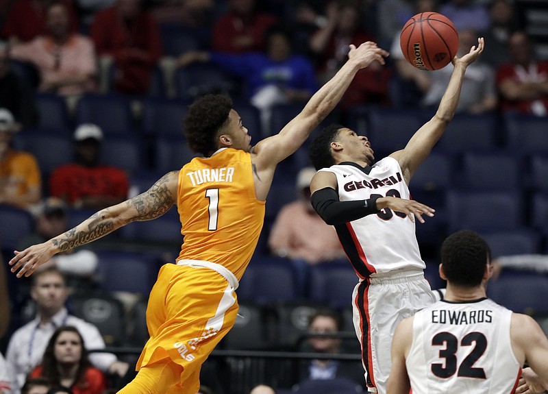 Tennessee's Lamonte Turner and Georgia's J.J. Frazier battle for a loose ball during their second-round game at the SEC tournament Thursday afternoon in Nashville. Georgia won 59-57 to advance to a quaterfinal against top-seeded Kentucky today.