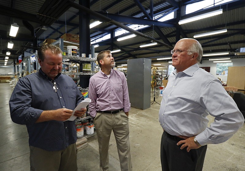 Dennis Neal, Glen Golden and David Butler, from left, speak about energy efficient updates made to the Habitat for Humanity Restore off of E. Main Street on Monday, August 17, 2015. the Restore is one of a few dozen Chattanooga businesses that are LEED certified. 