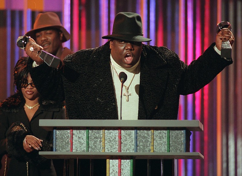 
              FILE - In this Dec. 6, 1995, file photo, The Notorious B.I.G., who won rap artist and rap single of the year, clutches his awards at the podium during the Billboard Music Awards in New York. The rapper was remembered by Sean "Diddy" Combs and others on March 9, 2017, 20 years after his death. (AP Photo/Mark Lennihan, File)
            