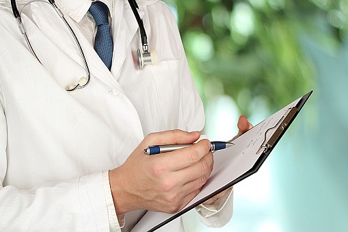 Medical doctor  with a stethoscope around his neck  holding