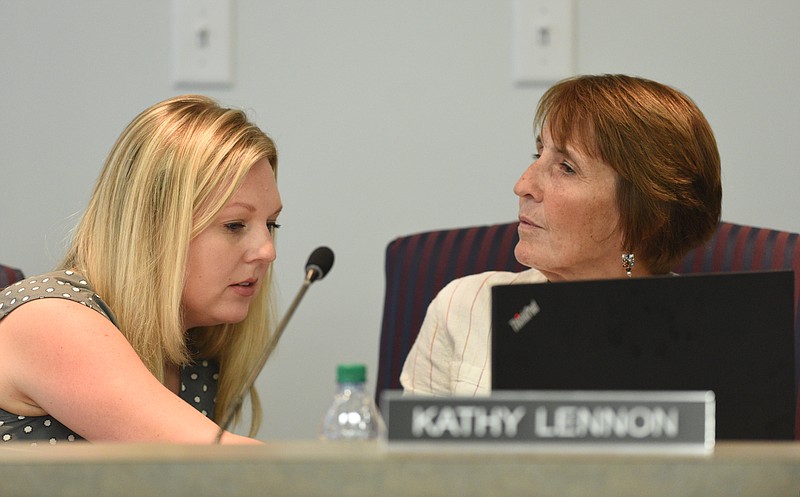 Members Tiffanie Robinson, left, and Kathy Lennon, both elected last August, talk during a September meeting of the Hamilton County Board of Education.