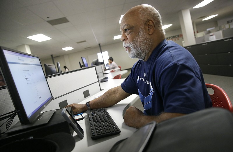 Air Force veteran Thom Brownell uses a computer to search for a job at the Texas Workforce Solutions office in Dallas, Friday, March 10, 2017. U.S. employers added a robust 235,000 jobs in February and raised pay at a healthy pace, making it all but certain that the Federal Reserve will raise short-term interest rates next week. Friday's jobs report from the government made clear that the economy remains on solid footing nearly eight years after the Great Recession ended. (AP Photo/LM Otero)