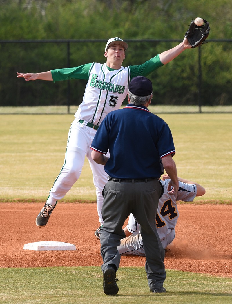 East Hamilton's Nick Woods stretches for an errant throw as Walker Valley's Grayson Roundtree slides during a game in 2015. Woods has been seriously injured twice while playing football, but he is back for his senior season on the diamond and has signed with Tennessee's baseball program.