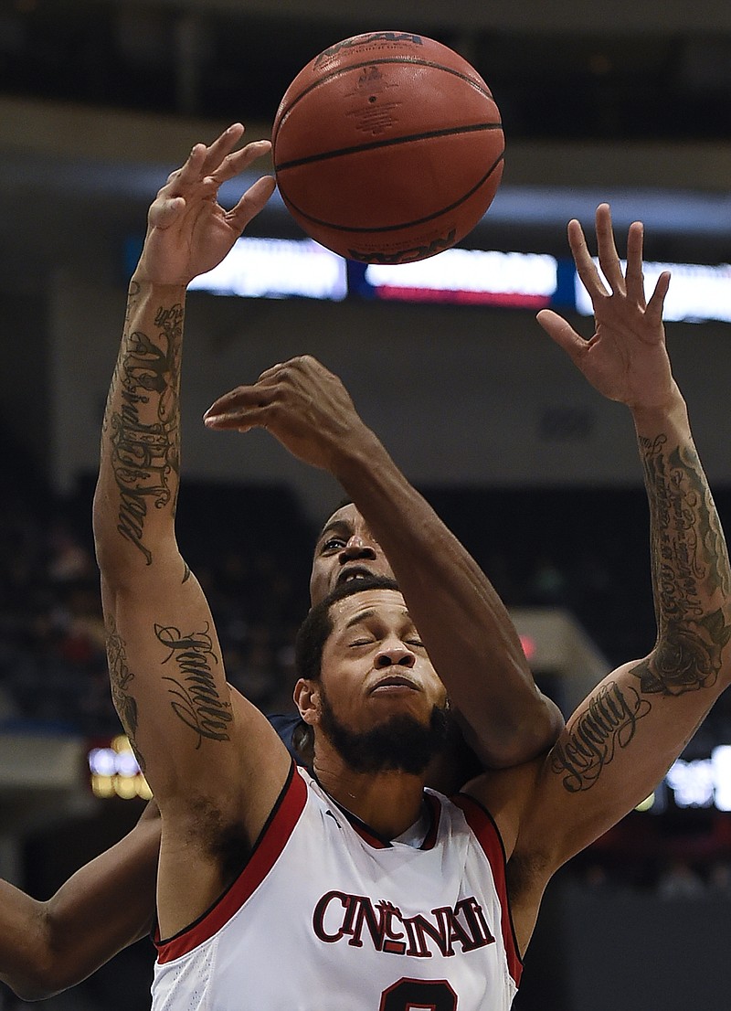 
              Connecticut's Kentan Facey, back fouls Cincinnati's Quadri Moore during the first half of an NCAA college basketball game in the American Athletic Conference tournament semifinals, Saturday, March 11, 2017, in Hartford, Conn. (AP Photo/Jessica Hill)
            