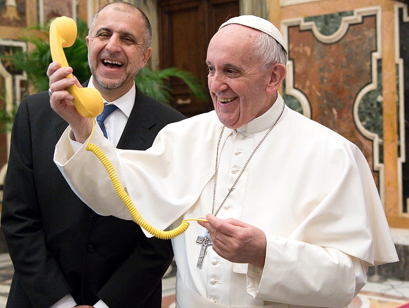 
              Pope Francis shares a light moment with "Telefono Amico" support hotline president Dario Briccola during an audience at the Vatican Saturday, March 11, 2017. (L'Osservatore Romano/Pool Photo via AP)
            