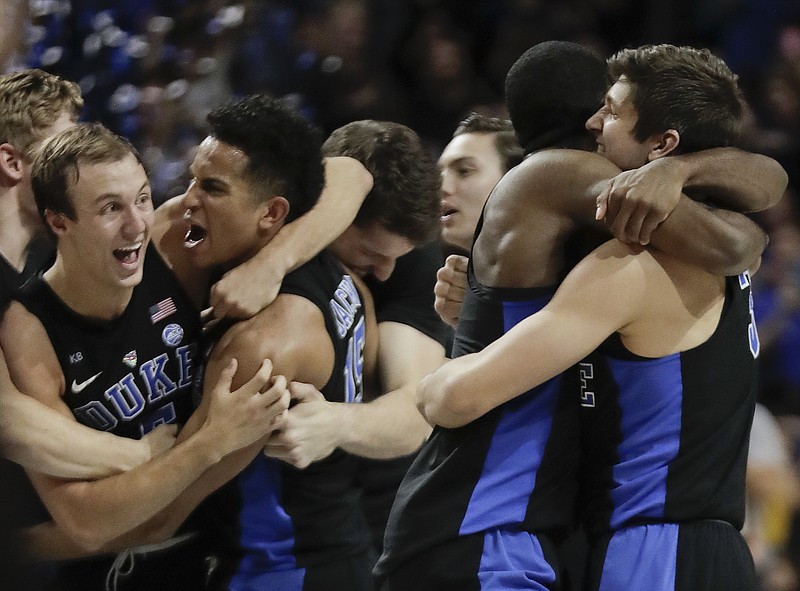 Duke players celebrate after beating Notre Dame 75-69 in the ACC tournament championship game Saturday night in New York.