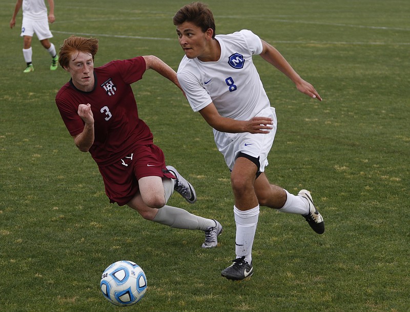 Staff Photo by Dan Henry / The Chattanooga Times Free Press- 5/25/16. McCallie School's Will McGregor (8) dribbles past Montgomery Bell Academy's Ellis Moore during the 2016 TSSAA Division II State Soccer Championship Match at the Richard Siegel Soccer Complex in Murfreesboro, TN., on May 25, 2016. McCallie lost 0-1. 