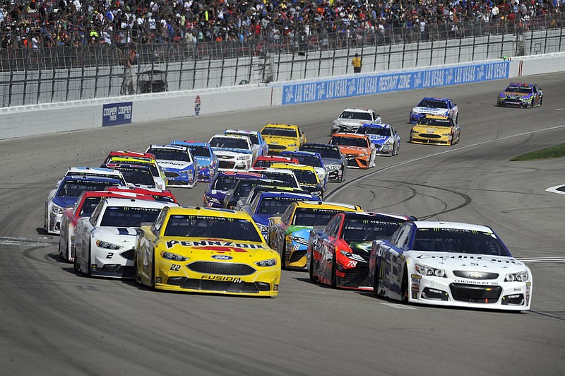 
              Joey Logano (22) and Jamie McMurray (1) lead the pack as they come out of a caution lap during a NASCAR Cup Series auto race Sunday, March 12, 2017, in Las Vegas. (AP Photo/David Becker)
            