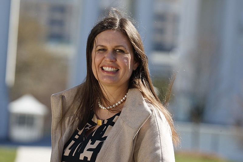 
              In this March 8, 2017, photo, White House deputy press secretary Sarah Huckabee Sanders stands in front of the White House in Washington. Faced with aggressive on-air questioning about the president’s wiretapping claims, Sarah Huckabee Sanders didn’t flinch, she went folksy. The 34-year-old spokeswoman for President Donald Trump was schooled in hardscrabble politics, and down-home rhetoric, from a young age by her father, folksy former Arkansas Gov. Mike Huckabee. (AP Photo/Evan Vucci)
            