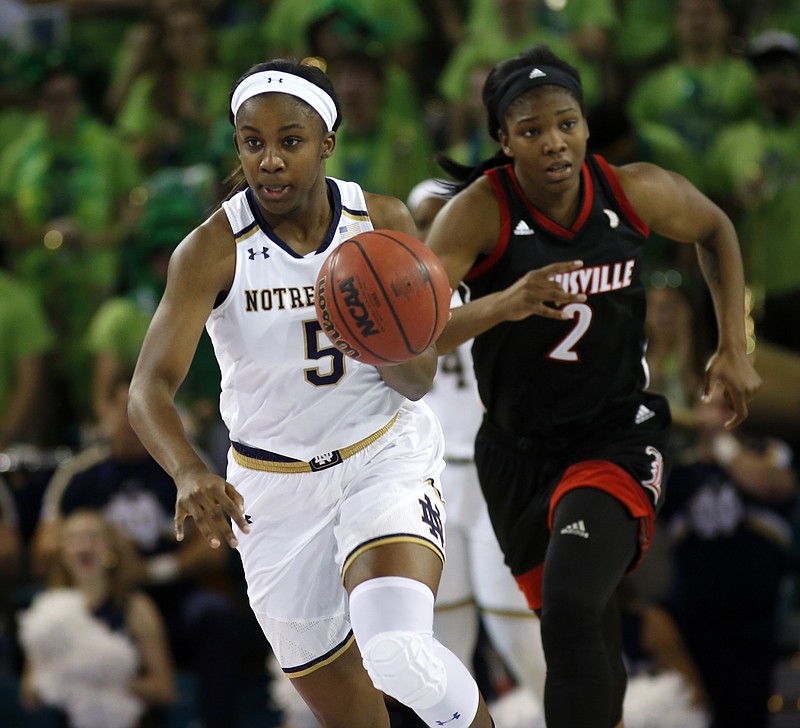 Notre Dame's Jackie Young, left, pushes the ball up court ahead of Louisville's Myisha Hines-Allen, during the first half of an NCAA college basketball game in the Atlantic Coast Conference tournament at the HTC Center in Conway, S.C., Saturday, March 4, 2017. (AP Photo/Mic Smith)