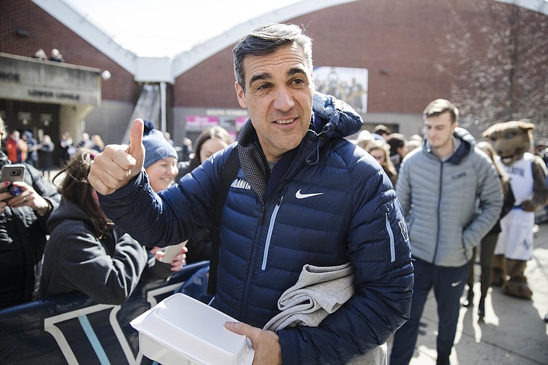 
              Villanova NCAA college basketball head coach Jay Wright gestures before boarding a bus as the team departs Villanova, Pa., on Monday, March 13, 2017, for a game in the first round of the NCAA Tournament, in Buffalo, N.Y. Teams chasing a college basketball title are contending with an unexpected wrinkle that's making last-minute travel plans even tougher: the anticipation of a storm bearing down on the Northeast that's expected to dump snow and wind. (AP Photo/Matt Rourke)
            